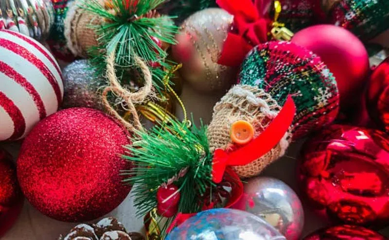 Hand-decorated red, gold and silver Christmas baubles with glitter and fabric details
