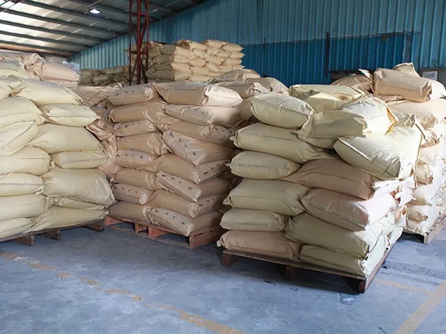Bagged material stacked on pallets in a storage area, from the XUCAI source website